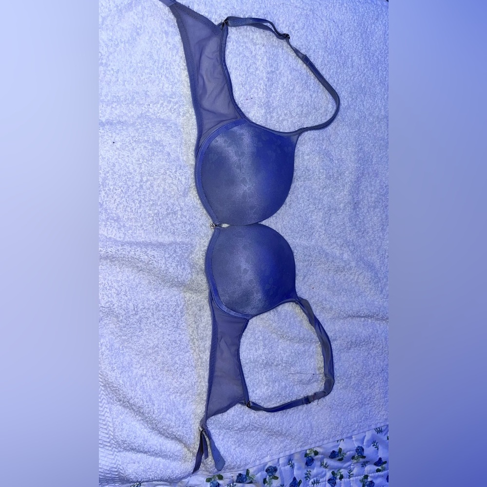 A soft periwinkle 32C Victorious Secret bra with shear straps going around.